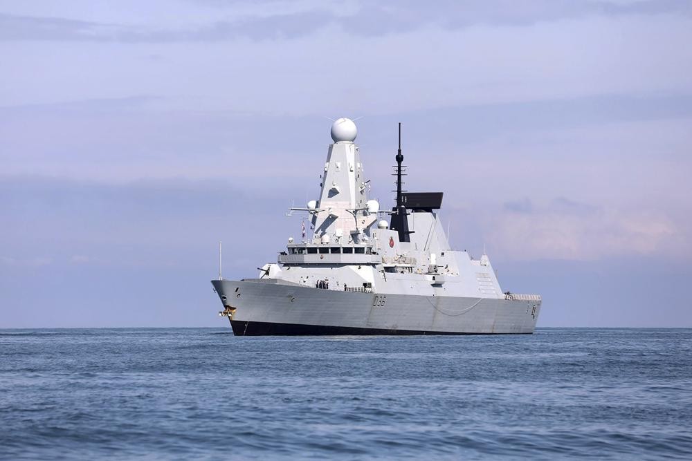 FILE - In this Saturday, June 26, 2021 file photo, released by the Georgian Interior Ministry, British destroyer HMS Defender arrives at the port of Batumi, Georgia. Sensitive defense documents containing details about the British military have reportedly been found at a bus stop in England. The BBC reported Sunday, June 27, 2021 that the papers included plans for a possible U.K. military presence in Afghanistan. They also included discussion about the potential Russian reaction to the British warship HMS Defender’s travel through waters off the Crimea coast last week. (Georgian Interior Ministry via AP, File)